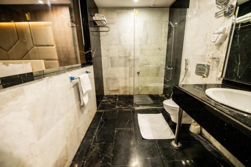 a bathroom with a sink and a toilet at Mora Hotel By Pioneer in Jeddah
