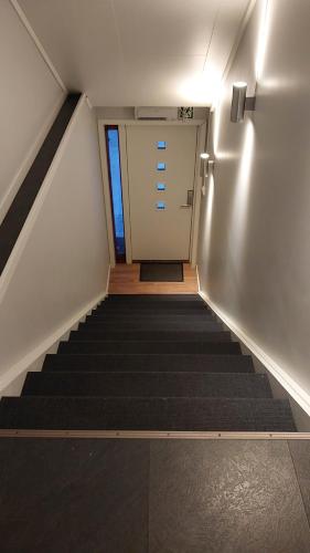a staircase leading to a door in a building at Lyngen Apartments in Lyngseidet