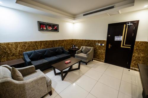 a living room with couches and chairs and a table at Mora Hotel By Pioneer in Jeddah