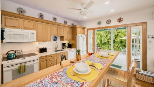 a kitchen with a table and a dining room at Casa Serendipity by Last Key Realty in Key West