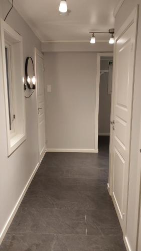 an empty room with white walls and a hallway at Lyngen Apartments in Lyngseidet