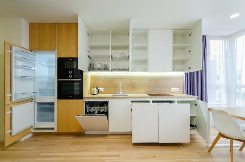 a kitchen with white cabinets and a sink at Petrovdom Apartments 78-170 in RC Nivki Park, 67А Beresteiskyi Avenue in Kyiv