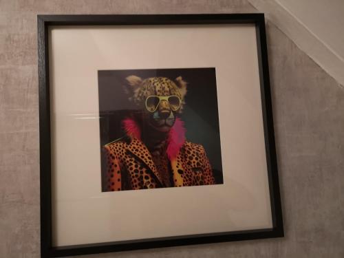 a picture of a person wearing a leopard mask and sunglasses at Superbe cocon de 44m2 in Longvic