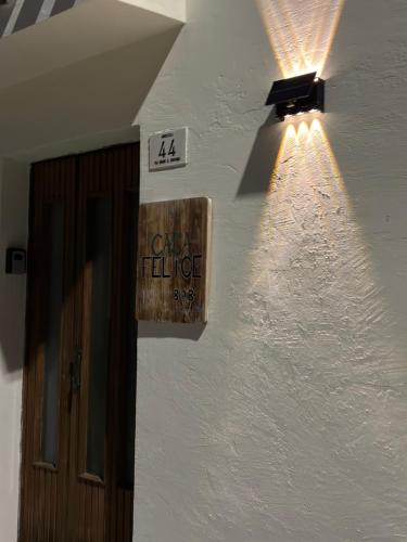 a light on the side of a white building at Casa Felice in Senigallia