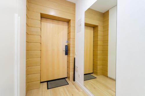 two doors in a hallway with wood paneling at Petrovdom Apartments 78-170 in RC Nivki Park, 67А Beresteiskyi Avenue in Kyiv