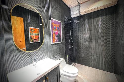 a bathroom with a sink and a toilet and a mirror at Z Loft Seaside FashionDesigner Loft in Bophut 
