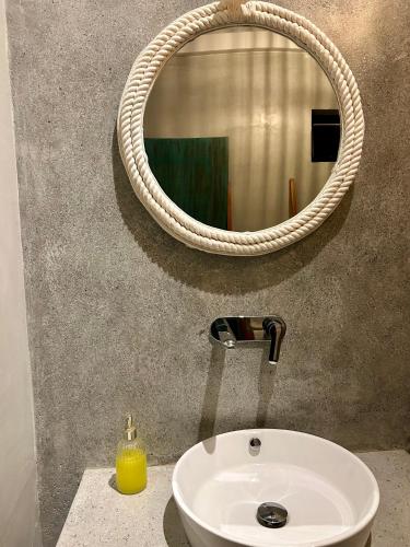a bathroom with a white sink and a mirror at Māna in Atadahewatugoda