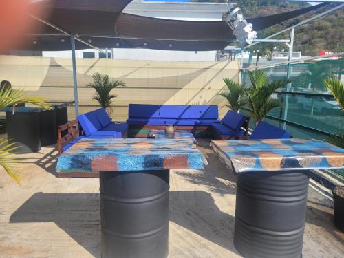 a patio with a table and chairs on a building at Pata in La Gaulette