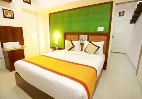 a bedroom with a large bed in a room at Base9 Family Lounge -Cochin Airport in Nedumbassery