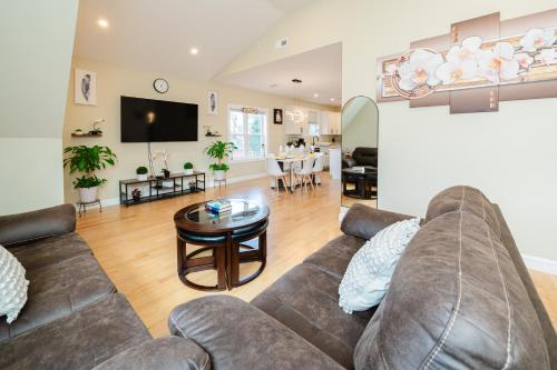 a living room with a couch and a table at 60-3 3BR Boston - Sleek Apartment near Franklin Park in Boston