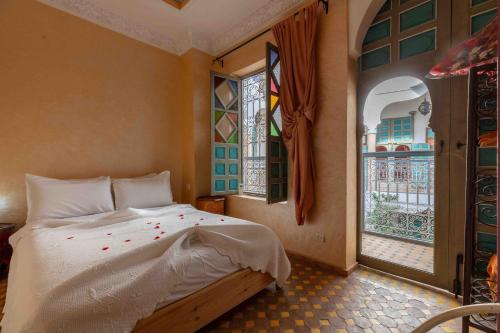 a bedroom with a bed and a window at Riad Zinoun & Spa 11 Rooms in Marrakesh