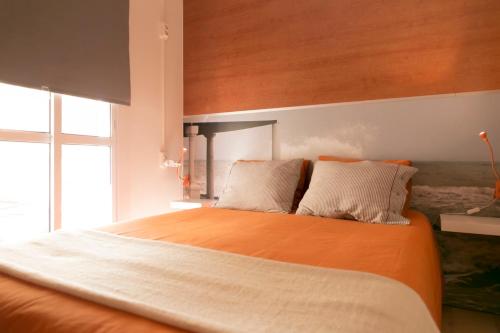 
a bedroom with a bed and a window at Chinitas Urban Hostel in Málaga
