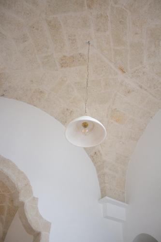 a chandelier hanging from a ceiling in a room at Dimora Lauré in Fasano