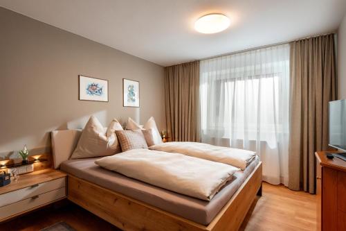 a hotel room with a bed and a television at Appartement Maria Theresia in Hopfgarten im Brixental