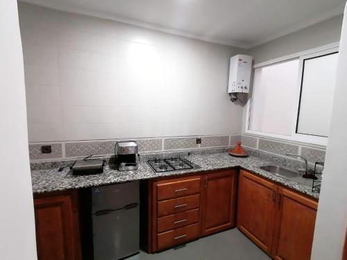 a kitchen with a sink and a counter top at Banana Beach Flat in Agadir