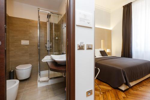 a bathroom with a bed and a toilet and a sink at Domus Terenzio in Rome