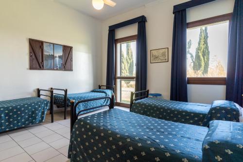 a waiting room with blue beds and windows at Hotel Il Lato Azzurro - Isola di Sant'Erasmo - NO VEHICLES ACCESS in Venice