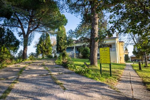 a road in front of a house with trees at Hotel Il Lato Azzurro - Isola di Sant'Erasmo - NO VEHICLES ACCESS in Venice