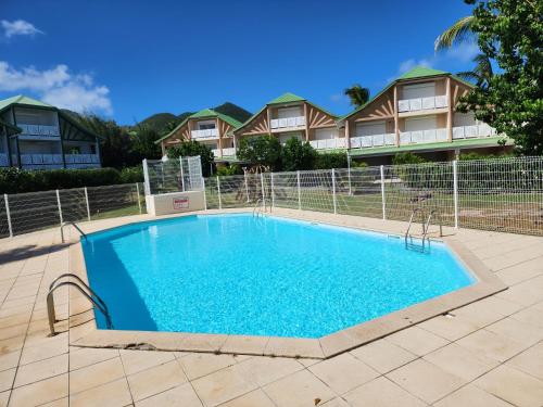 a swimming pool in front of some houses at Zion Appartement SXM in Orient Bay