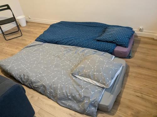two beds sitting on the floor in a room at Chambre confortable au calme et proche du centre-ville de Lyon in Lyon