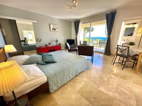 a bedroom with a bed and a living room at Villa Grand Baie in Agay - Saint Raphael