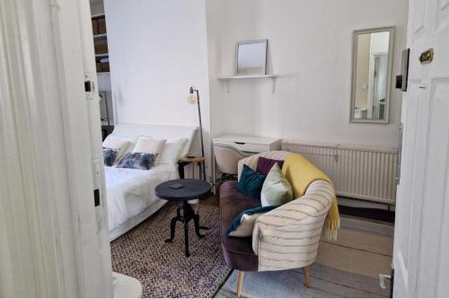 a living room with a couch and a bed at Charming Studio Sleeps 2 - Kentish Town NWLondon in London