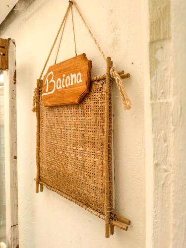 a sign that says baloma hanging on a wall at Casa da Glória Trancoso - Pousada Boutique in Trancoso