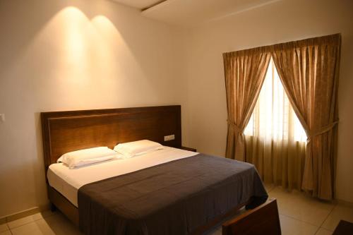 a bedroom with a large bed and a window at Nadackal Nature County in Munnar