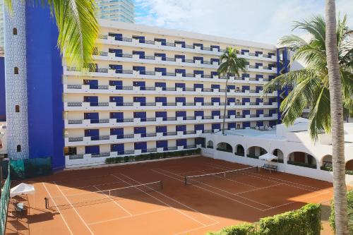 a hotel with a tennis court in front of it at Crown Paradise Golden All Inclusive Resort - Adults Only in Puerto Vallarta