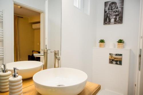 a bathroom with two white sinks in a room at Nova Studio Apartments in Reghin