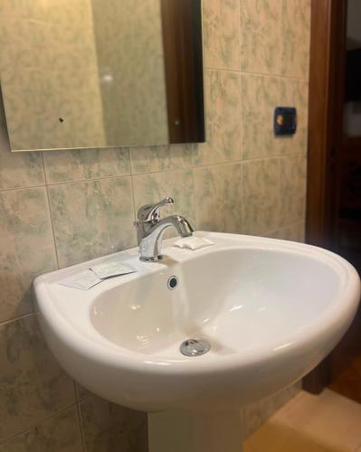 a white sink in a bathroom with a mirror at Tenuta Gran Bosco in Loro Piceno