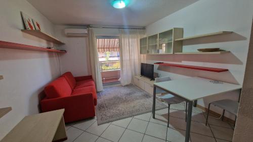 un salon avec un canapé rouge et une table dans l'établissement Riviera Beach, à Roquebrune-Cap-Martin