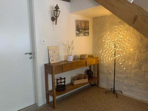 a room with a table with a tree on the wall at Chambres d'Hôtes La Petite Odile in Boersch