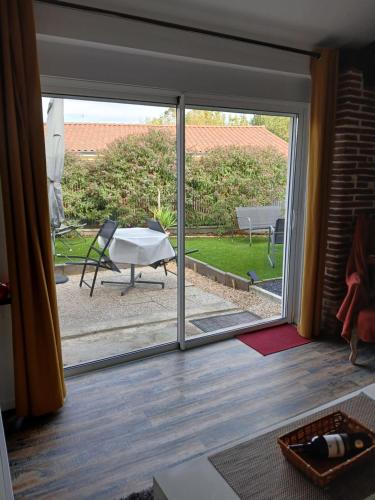 a sliding glass door with a view of a patio at Gite de PHAM in Belberaud