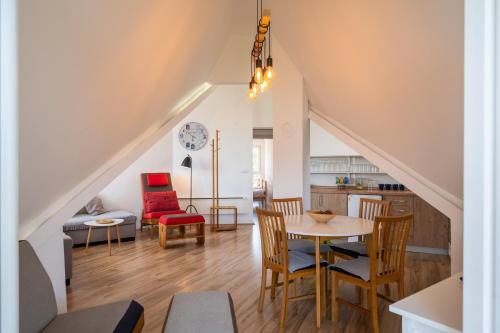 a kitchen and living room with a table and chairs at Apartman Senka 2 in Divčibare