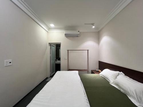 a bedroom with a large bed in a room at Lá house Hà Nội in Dong Anh