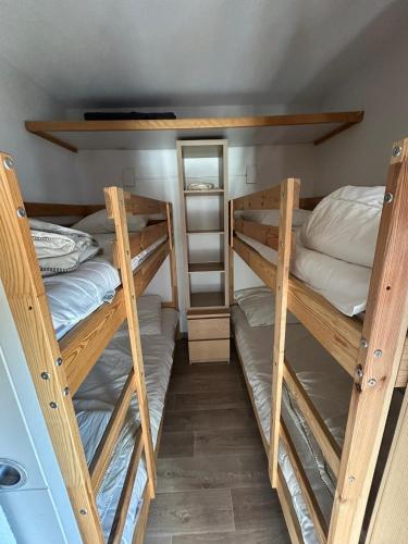 a room with two bunk beds and a mirror at Altineige 210 in Val Thorens