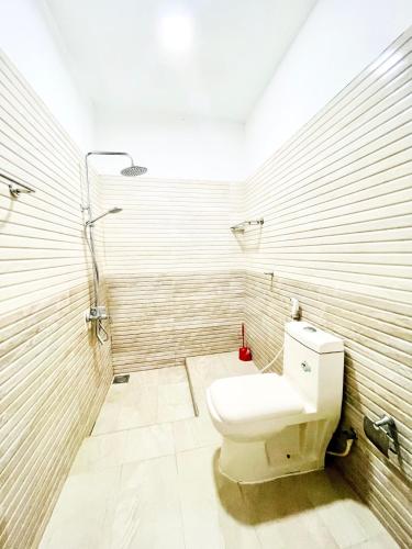 a bathroom with a toilet and a shower at Sebastian Family Villa in Negombo
