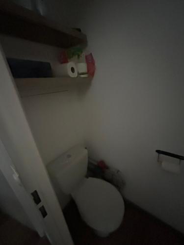 a bathroom with a white toilet in a room at Altineige 210 in Val Thorens