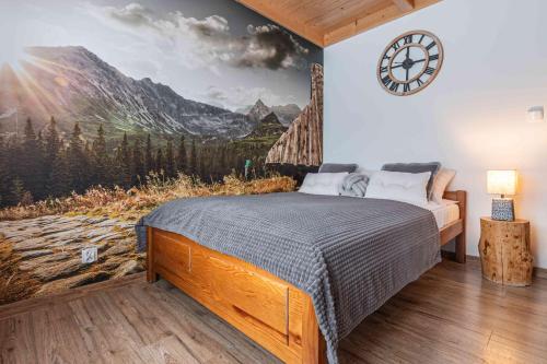 a bedroom with a bed with a mountain mural at Goralove Pole in Brzegi