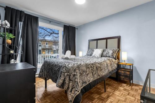 a bedroom with a bed and a window at COSY 3 BEDROOMS Montreal in Montréal