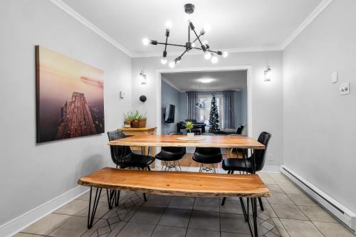 a dining room with a wooden table and chairs at COSY 3 BEDROOMS Montreal in Montréal