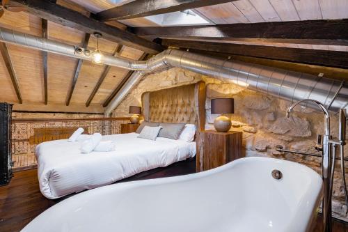 a bedroom with a bed and a bath tub at Palacio Sempere in Alicante