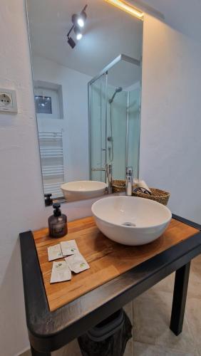 a bathroom with a sink and a large mirror at DreamPlace Airport & Therme 1 in Otopeni