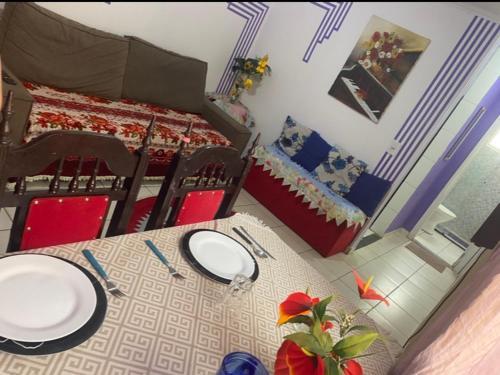 a dining room with a table and a bed at Hostel Gonzales in Votorantim