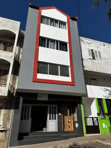 a tall white building with a red trim at T1 Férias Mindelo in Mindelo