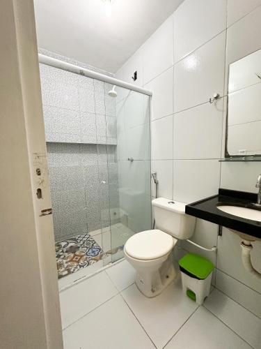 a bathroom with a shower and a toilet and a sink at Hotel Oiticica in Fortaleza
