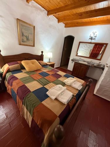 a bedroom with a large bed with towels on it at La Posta del Mistol in Las Tapias