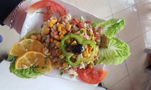 a salad with corn and vegetables on a plate at Hotel Espace Tifawine in Tafraoute