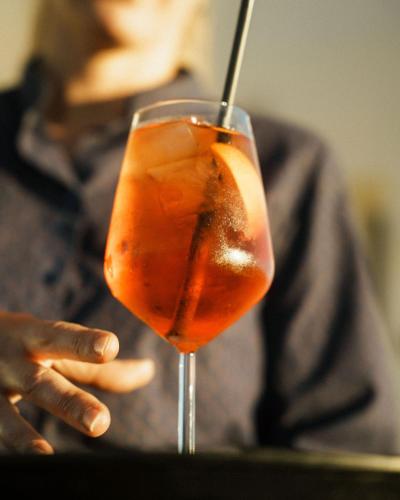 a person is holding a drink in a glass at Hotel Estepona Plaza in Estepona